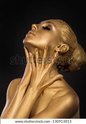  Coloring. Gilt. Golden Plated Woman's Face. Art concept. Gilded Body. Focus on her hands
