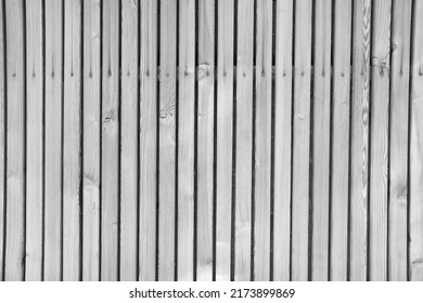 colorless background of wooden boards planks with nails and crevices, gaps