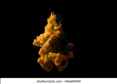 Colors Dropped Into Liquid And Photographed While In Motion. Ink Swirling In Water. Cloud Of Silky Ink In Water Isolated On Black Background. Colorful Ink In Water, An Abstract Banner. Color Drop.