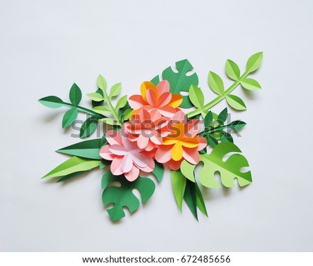 The colors of the paper. White background. Tropics. Paper flowers and leaves. Palma.