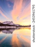 Colors of sunset reflected on the icy surface of Lake Sils, Engadine Valley, Graubunden, Switzerland, Europe