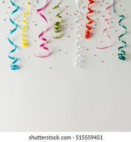 Colorul Party Streamers On Bright Background. Celebration Concept. Flat Lay.