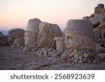 Colossal heads at Eastern terrace at the Mount Nemrut in southeatern Turkey at dawn. Mount Nemrut is notable for the summit where a number of large statues are erected around  the 1st century BC. 