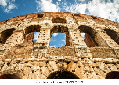 Colosseum or Coliseum, Rome, Italy, Europe. Ancient Colosseum is top landmark of Rome. Low angle close view of Colosseum stone wall. Concept of time, sightseeing, Roman Empire and past civilization.