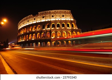 Colosseum And Traffic Lights At Night In Rome, Italy