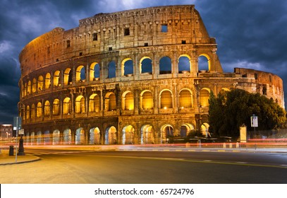 Colosseum And Traffic Lights At Night In Rome, Italy