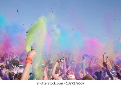 Colour Burst Of Powder With Arms In The Air And People