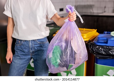 Colour of recycle trash bin help people easy manage the waste. recycling symbol on colourful waste cans. Recycling is good way for environmental protection. cropped woman with rubbish in hands - Powered by Shutterstock