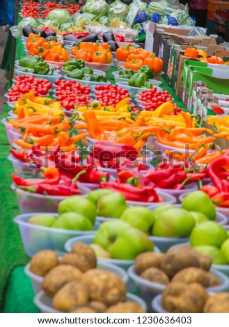 Colour selection of fruit and vegetables on a market stall table.