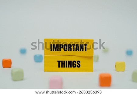 A coloured block with text IMPORTANT THINGS surrounded by colorful beads