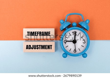 A coloured block with text TIMEFRAME ADJUSTMENT next to blue alarm clock