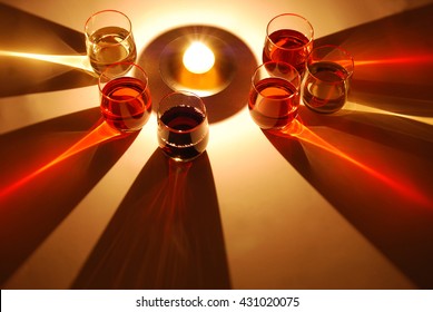 coloured shadows of wine glass illuminated by a candle