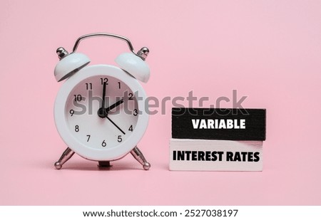 A coloured wooden block with text VARIABLE INTEREST RATES on it