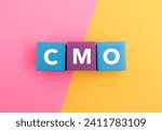 A coloured wooden block with word “CMO” on it. CMO stands for "chief marketing officer". Business and finance concept