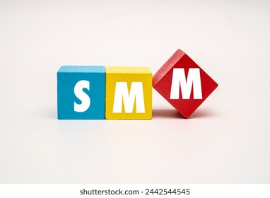 A coloured wooden block with word  “SMM” on it. SMM stands for “Social Media Marketing”