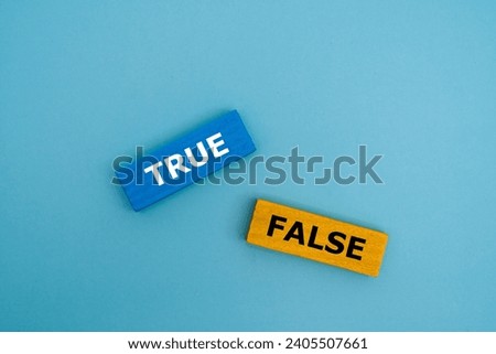 A coloured wooden block with word “TRUE, FALSE” on it