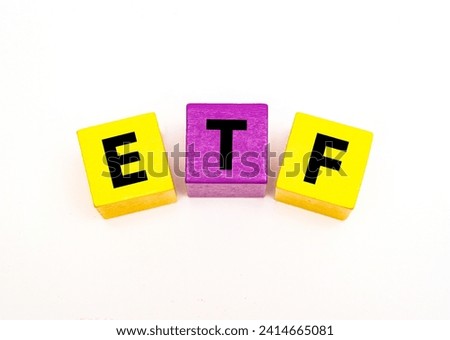 A coloured wooden block with word “ETF” on it. ETF stands for 
