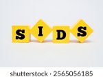 A coloured wooden cubes with text SIDS. SIDS stands for Sudden Infant Death Syndrome