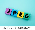 A coloured wooden cubes with word “JPEG” on it. JPEG stands for “Joint Photographic Experts Group”