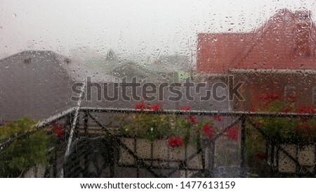 Similar – Rainy day I View through a wet window pane onto a busy street