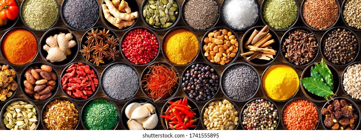 Colourful background from various herbs and spices for cooking in bowls. Top view - Shutterstock ID 1741555895