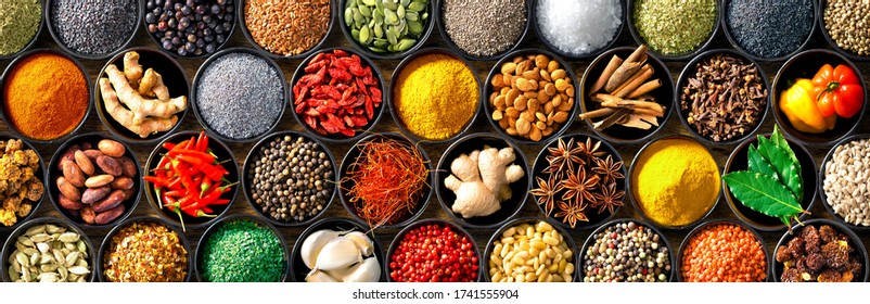 Colourful background from various herbs and spices for cooking in bowls. Top view - Shutterstock ID 1741555904