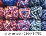 Colourful ball of yarn in storage. Warm wool yarn in vibrant colors. Knitting hobby. Row of vivid yarn. Handiwork store. Knit background. Handcraft concept. Knit pattern.