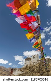 Colourful buddhist prayer flags fluttering from Namgyal Tsemo Gompa, an ancient monastery and temple on a mountain top in Leh, Ladakh, India