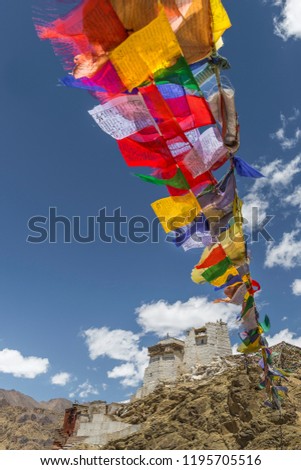 Colourful buddhist prayer flags fluttering from Namgyal Tsemo Gompa, an ancient monastery and temple on a mountain top in Leh, Ladakh, India