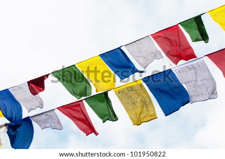 Colourful buddhist tibetan prayer flags waving in the wind over the sky at India.