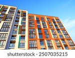 Colourful Building exterior. New house, home complex. Colored Facade building background. Modern building, houses with glass windows. New Buildings architecture. Residential apartment. Condominium.