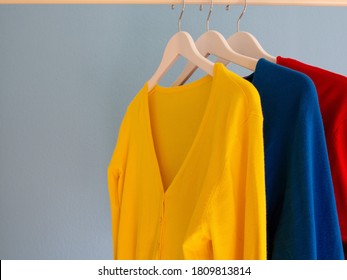 Colourful women’s cardigans hanging on a clothes rail
