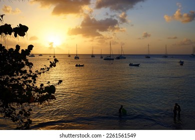 Colourful caribbean sunset with sailboats, Martinique island. French West Indies.