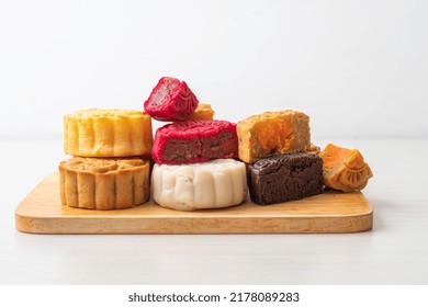 Colourful Chinese Moon Cake With Mixed Flavour On Wood Plate