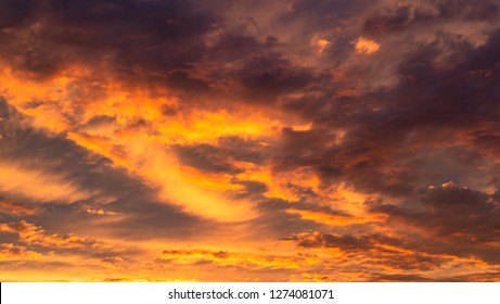 Colourful clouds at sunset. Dramatic exploding sunset. Fiery Sky. Beautiful stormy sunset sky. Cloudy abstract background. Sunset colors.