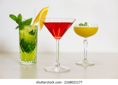 Colourful Cocktail Combo Platter, Includes Akafuji, Ikebana, With Vodka, Malibu, Gin, Midori Summer Yellow Green Red Drinks On Table Plain Background