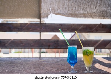 Colourful cocktails with ice on the beach in the hot summer
