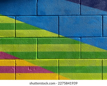 Colourful concrete block wall in an urban alleyway.
