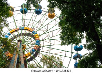 A Colourful Ferris Wheel. Front View. Against The Blue Sky On A Sunny Day