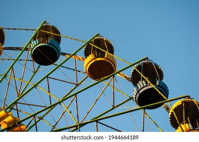 A Colourful Ferris Wheel. Front View. Against The Blue Sky On A Sunny Day