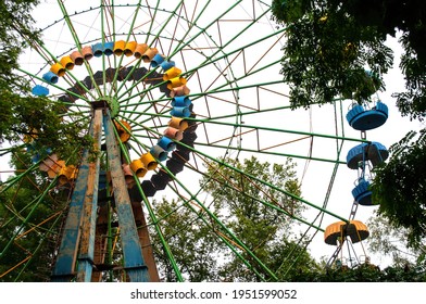 A Colourful Ferris Wheel. Front View. Against The Blue Sky On A Sunny Day