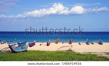 Colourful fishing boats on Dutch Bay beach in Trincomalee, Sri Lanka
