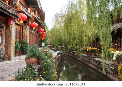 Colourful flowers lining a canal stream next to a cobbled street in Lijiang Old Town, Yunnan, China - Powered by Shutterstock