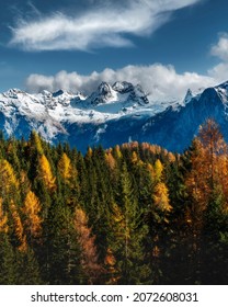 Colourful forest and Dolomite mountains surrounded by clouds in South Tyrol, Italy. View from Lago di Sorapis hiking trail  - Shutterstock ID 2072608031