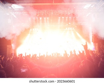 Colourful gig with a lit stage and festive crowd.