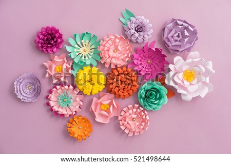 Colourful handmade paper flowers on pink background