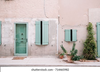 Colourful house wall facade, house with green door and shutters, Provence village, south France