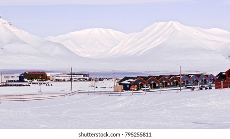 The Colourful Houses Of The Town Of Longyearbyen, The Largest Settlement And The Administrative Center Of Svalbard, Norway, The City Panoramic View At The Clear Sunny Spring Day With Rocks On The Back