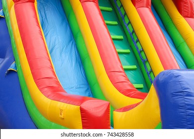 a colourful inflatable slide at a carnival - Shutterstock ID 743428558