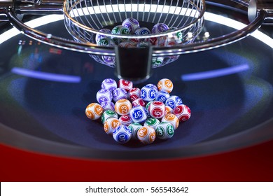 Colourful lottery balls in a rotating bingo machine.